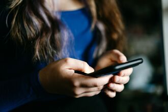 Close-Up of hands Holding a smartphone in casual setting