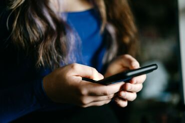 Close-Up of hands Holding a smartphone in casual setting