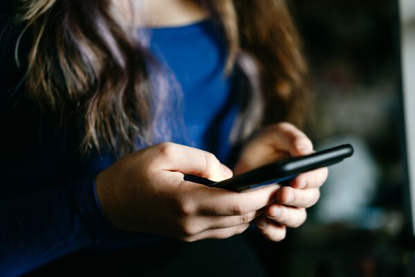 Close-Up of hands Holding a smartphone in casual setting