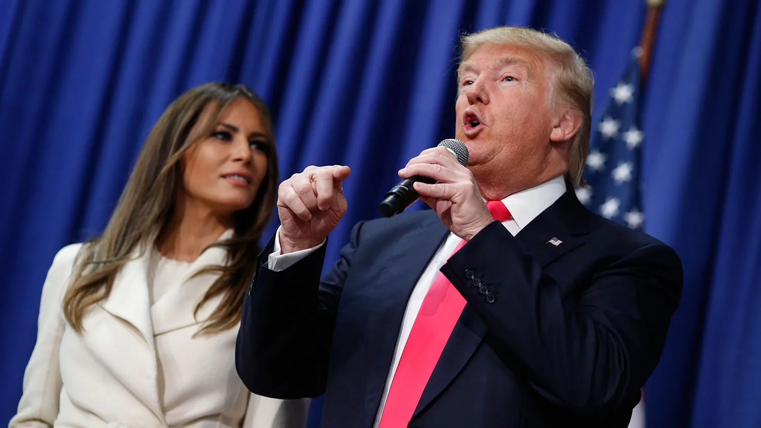 Donald Trump speaks while his wife, Melania Trump, listens during a campaign rally at the Gerald W. Kirn Middle School in Council Bluffs, Iowa, on Jan. 31, 2016.
