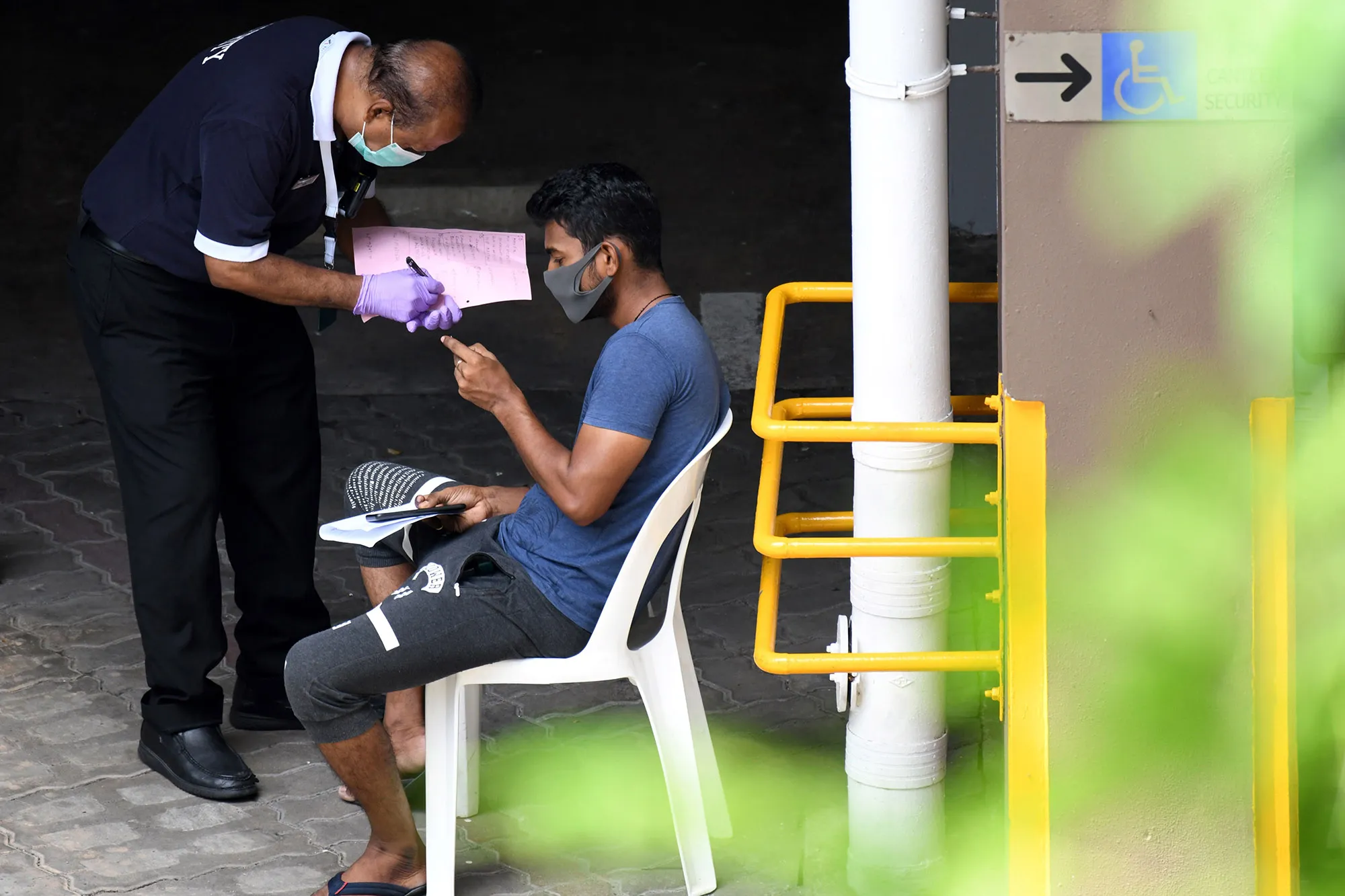 A security guard prepares to&nbsp;test for coronavirus in Singapore.