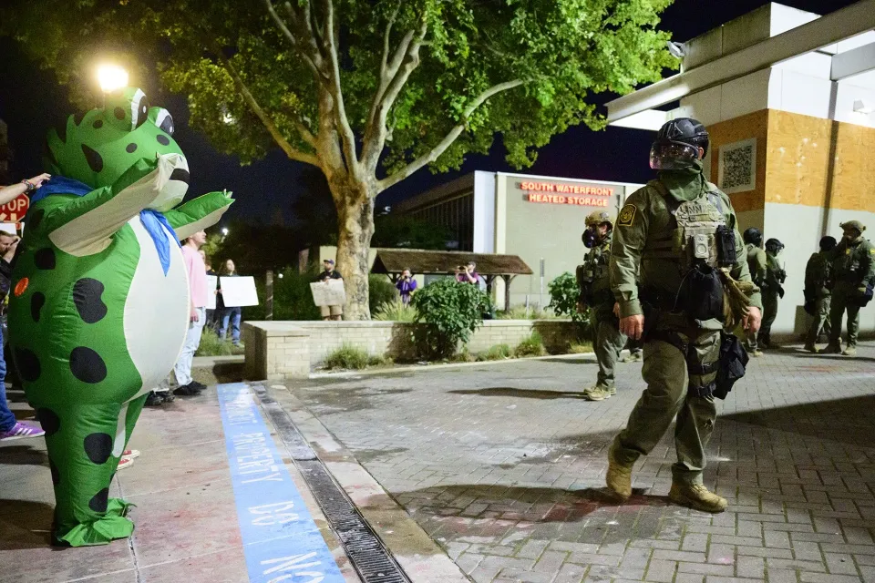 Federal agents stand guard to keep protestors away from an ICE facility in Portland, Oregon on Oct. 6.