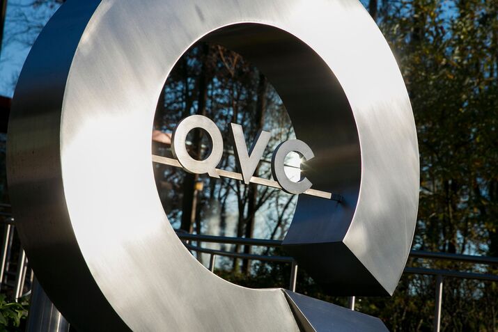 A logo sign outside of the headquarters of the television shopping channel, QVC, in West Chester, Pennsylvania on November 8, 20
