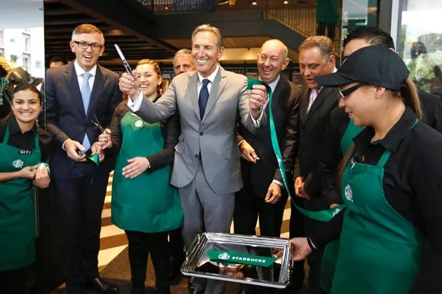 Howard Schultz, chairman and CEO of Starbucks cuts the ribbon during the opening ceremony for the first Starbucks in Bogota on July 16