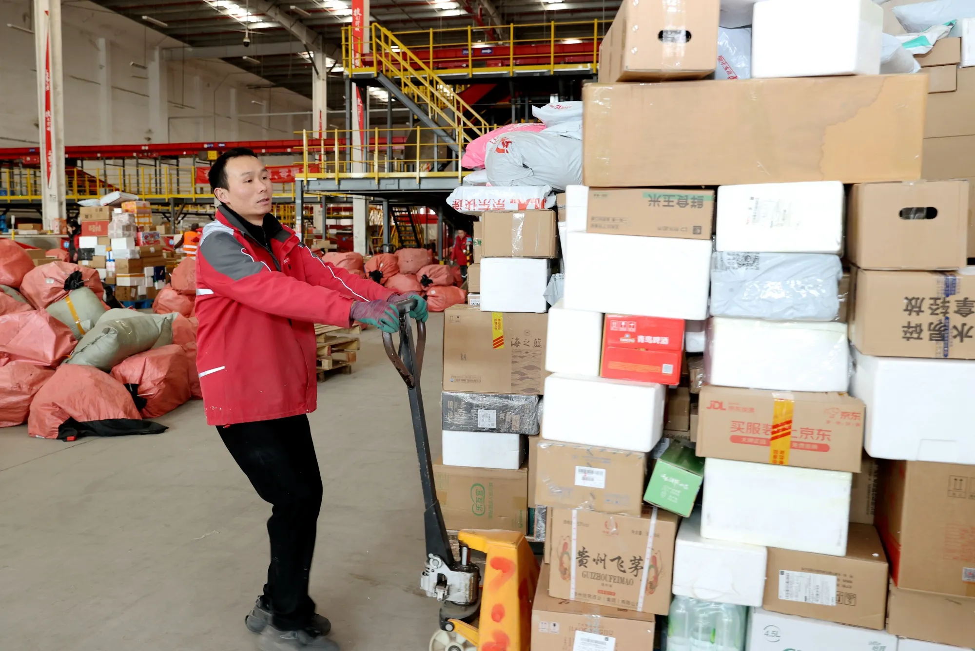 An employee sorts express parcels at a distribution center&nbsp;in Jiangsu Province.