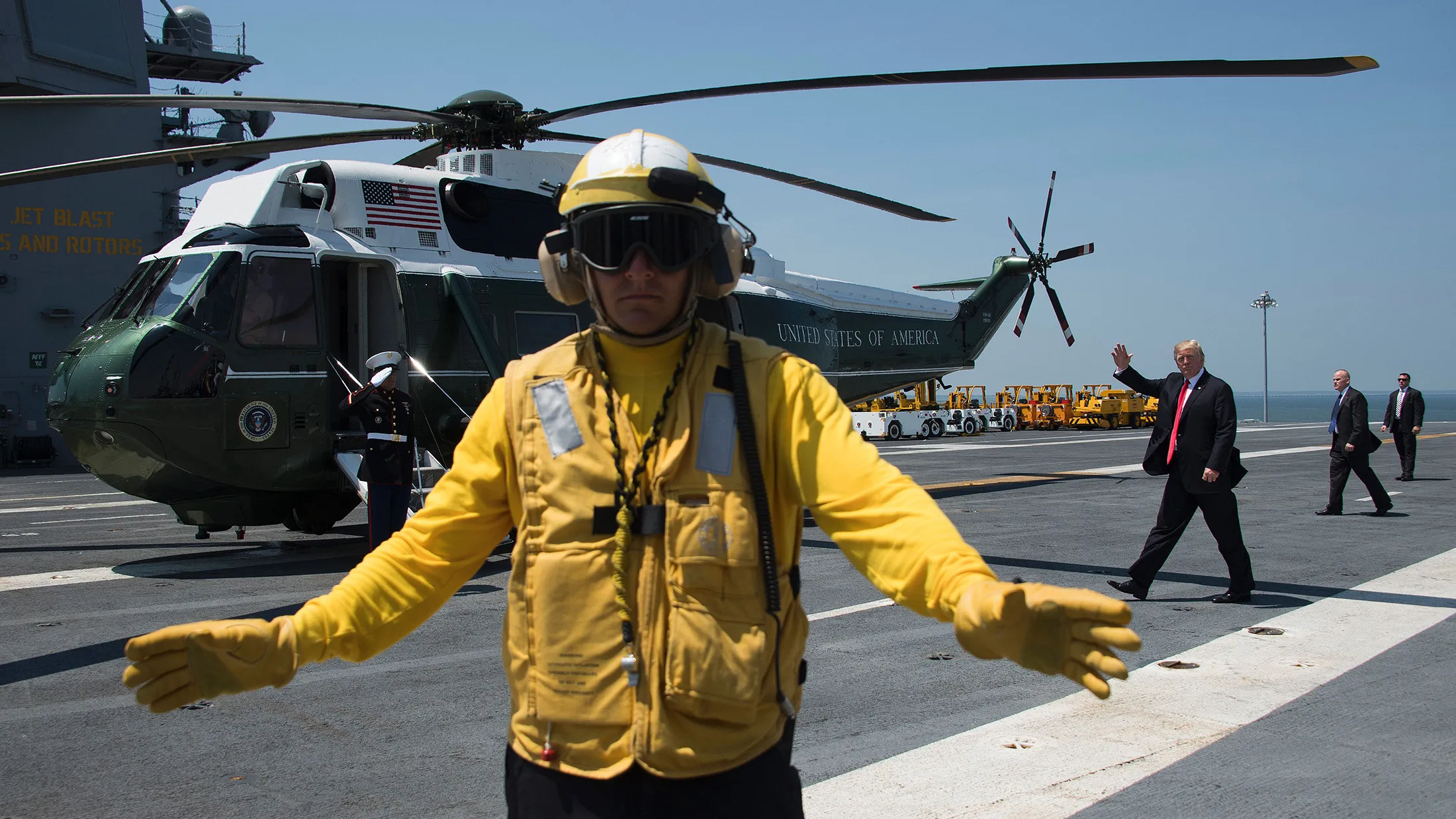 US President Donald Trump (3rd R) waves as he departs the USS Gerald R. Ford in Norfolk, Virginia, on July 22, 2017. ` / AFP PHOTO / JIM WATSON (Photo credit should read JIM WATSON/AFP/Getty Images)
