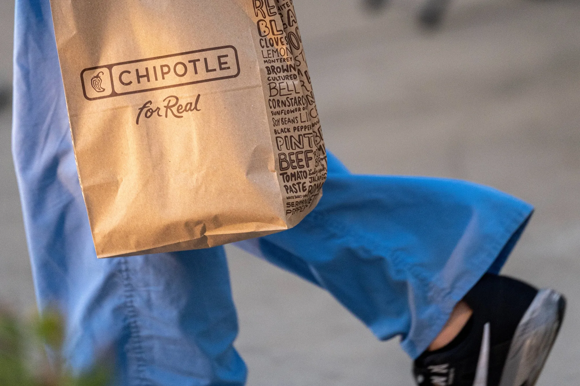 A customer carries a Chipotle bag in Santa Clara, California.
