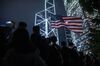 A U.S. national flag flies over demonstrators during a rally in support of the Hong Kong Human Rights and Democracy Act in Hong Kong, China, on Monday, Oct. 14, 2019. Protesters gathered in the city's central district in a police-sanctioned rally in support of the Hong Kong Human Rights and Democracy Act, a bill proposed in the U.S. to impose sanctions on the city.