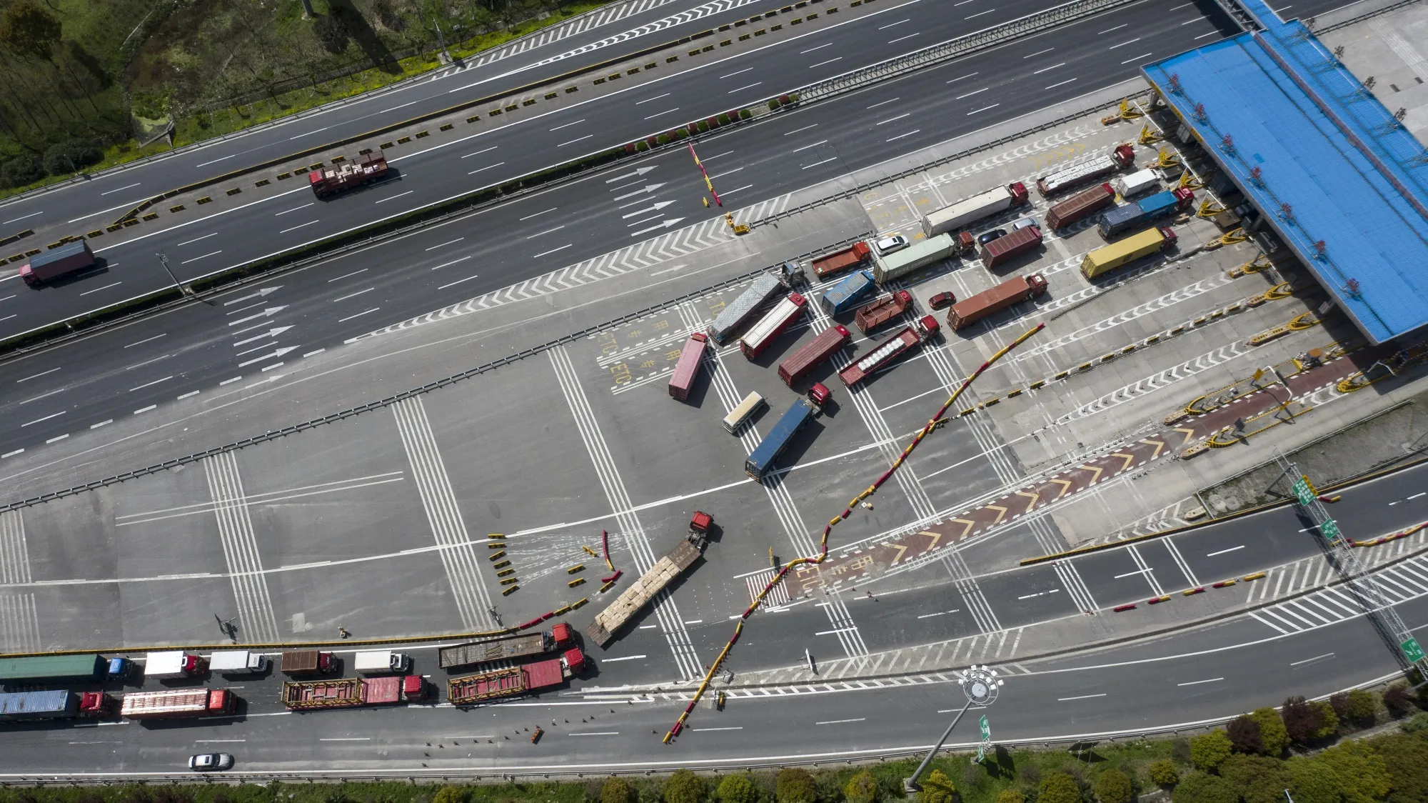 Trucks pass through a checkpoint in Shanghai.&nbsp;