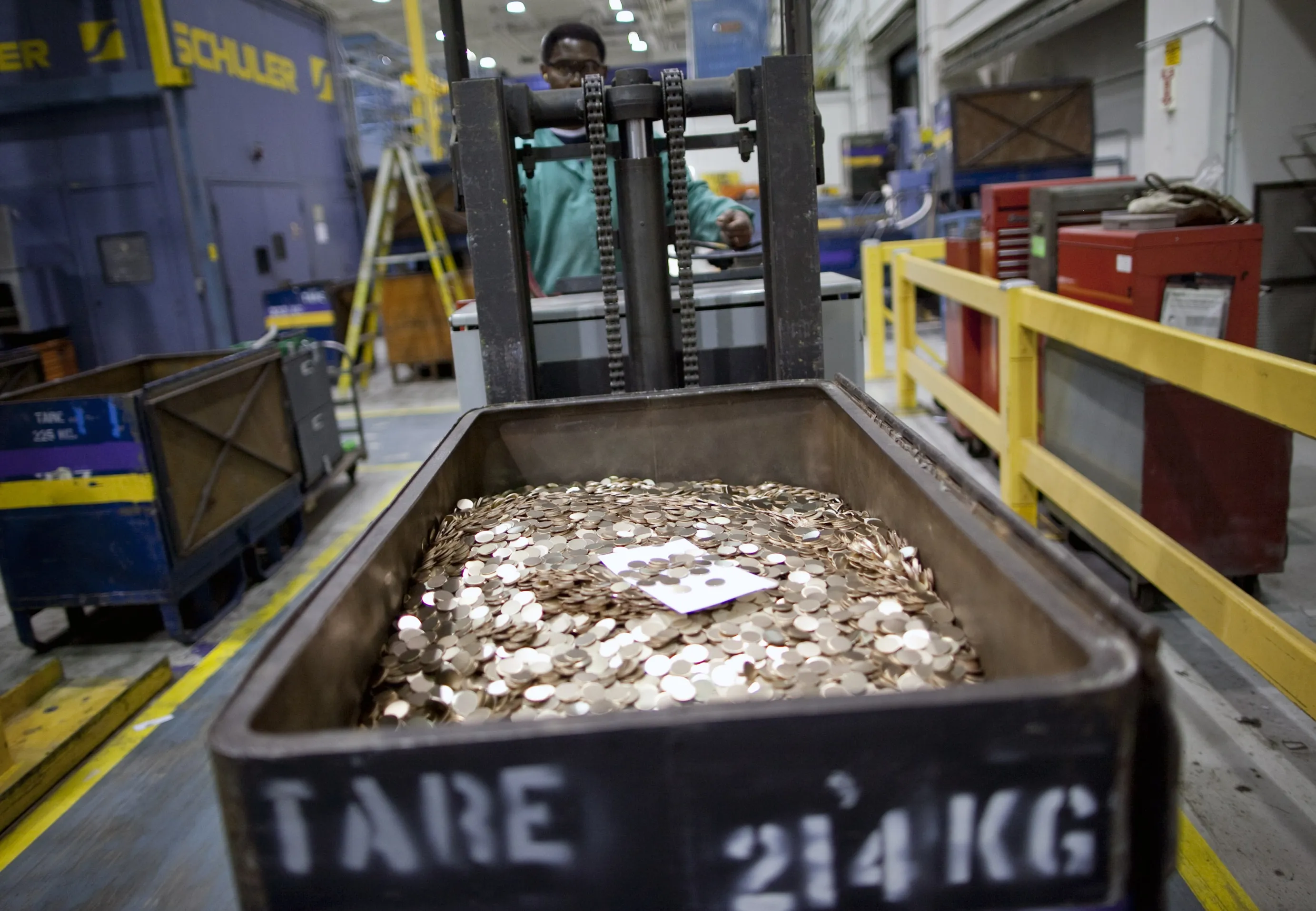 A machine operator transports penny blanks at the United States Mint in Philadelphia.