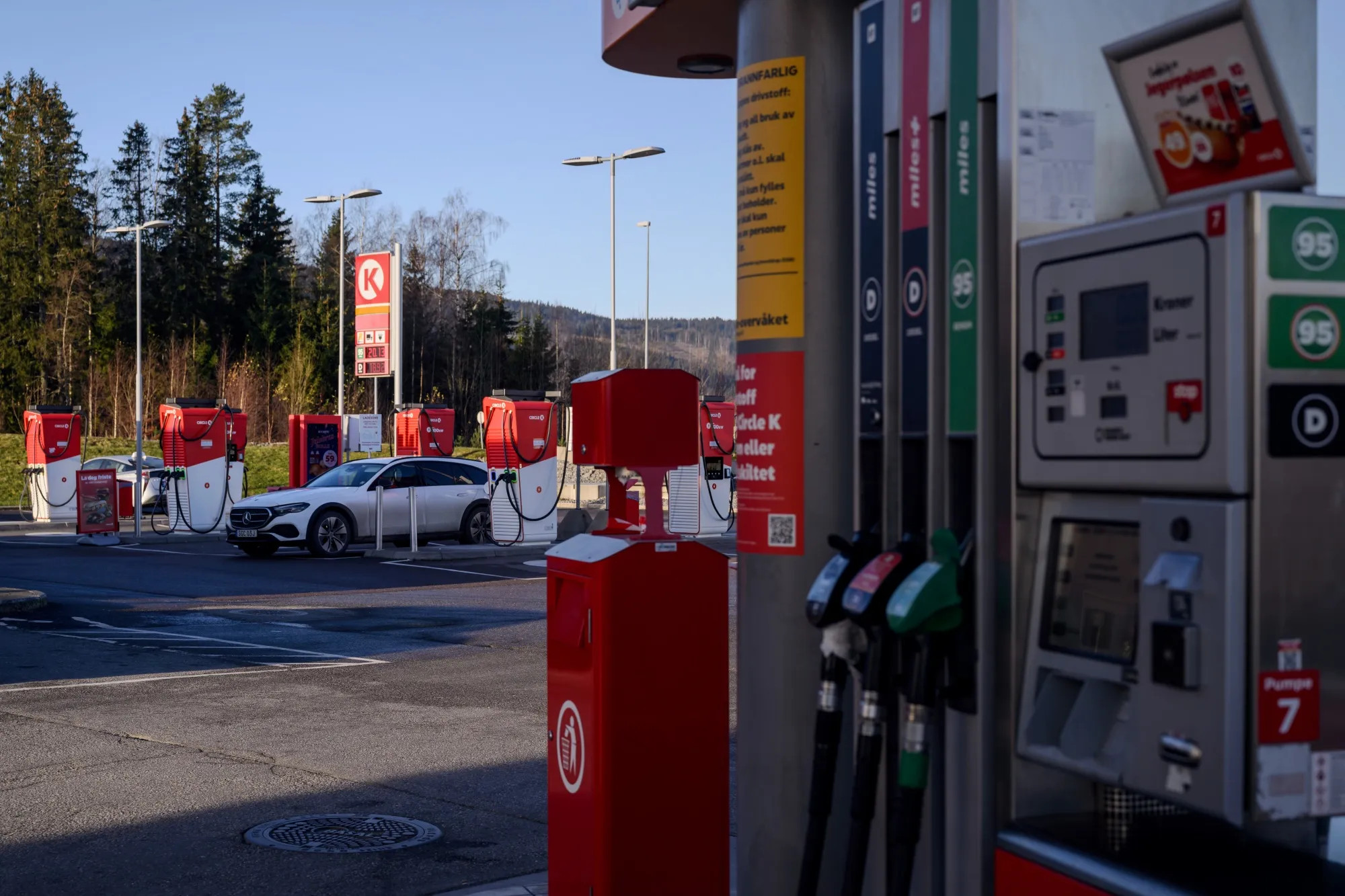 A gas pump and electric vehicle chargers at a service station in Minnesund, Norway.