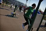A woman works out in an outdoor exercise area at Macombs Dam Park in the Bronx.