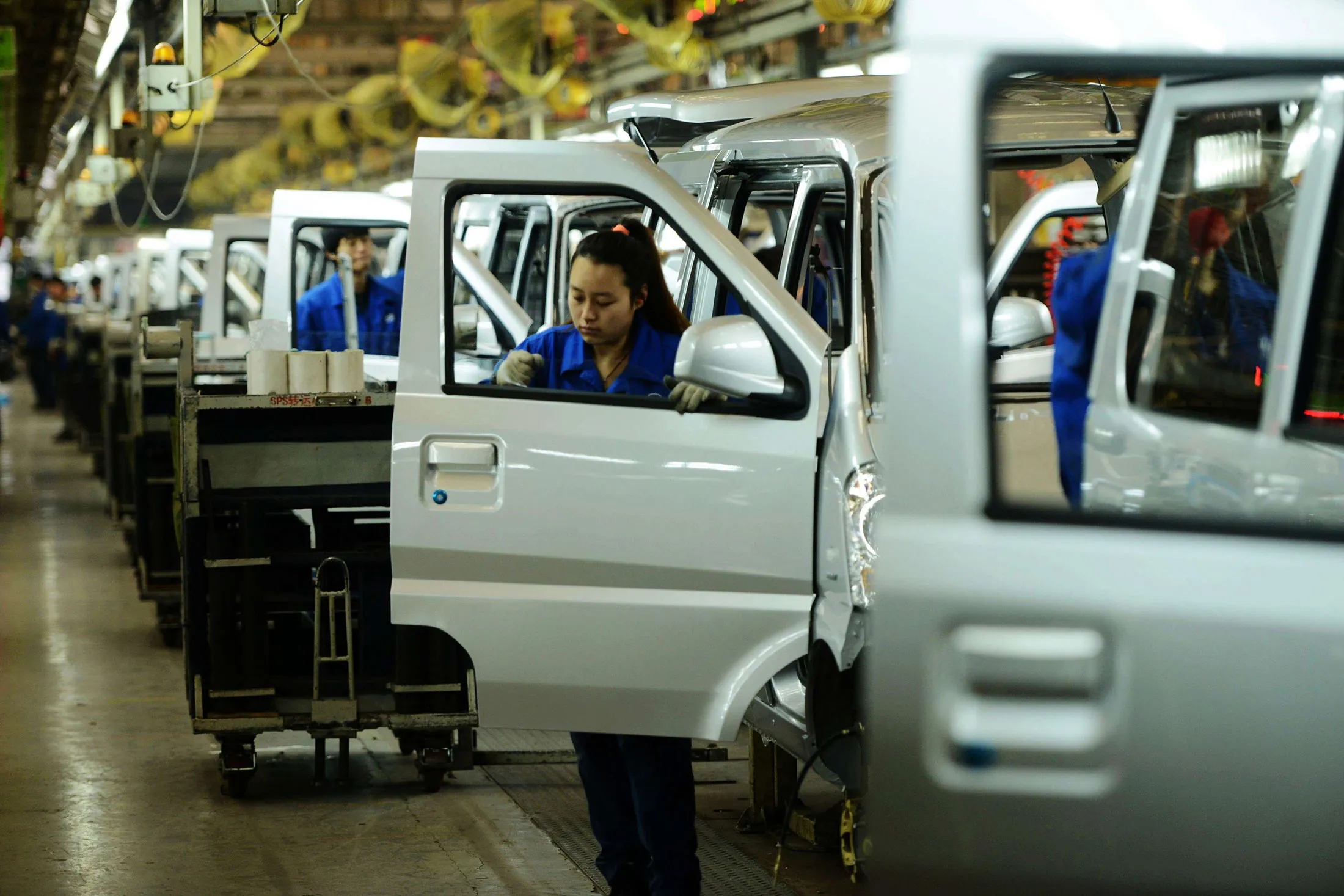 Workers at a branch of SAIC-GM-Wuling Automobile in Qingdao, Shandong province, on Jan. 9, 2014.
