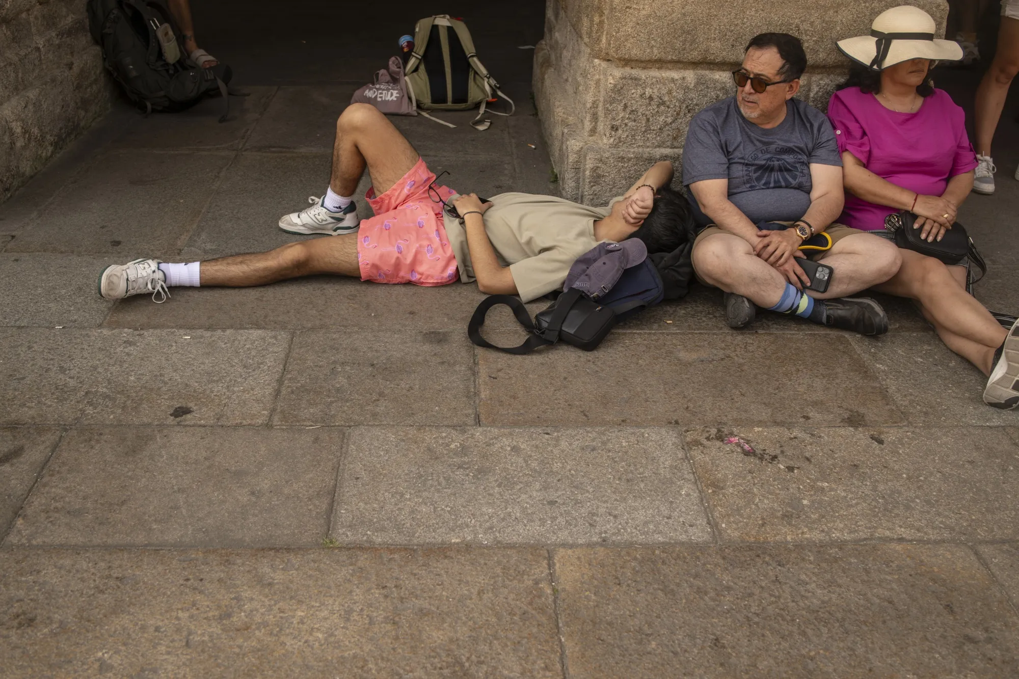 Tourists in the shade at Obradoiro Square during high temperatures in Santiago de Compostela, Spain, on Aug. 10.&nbsp;