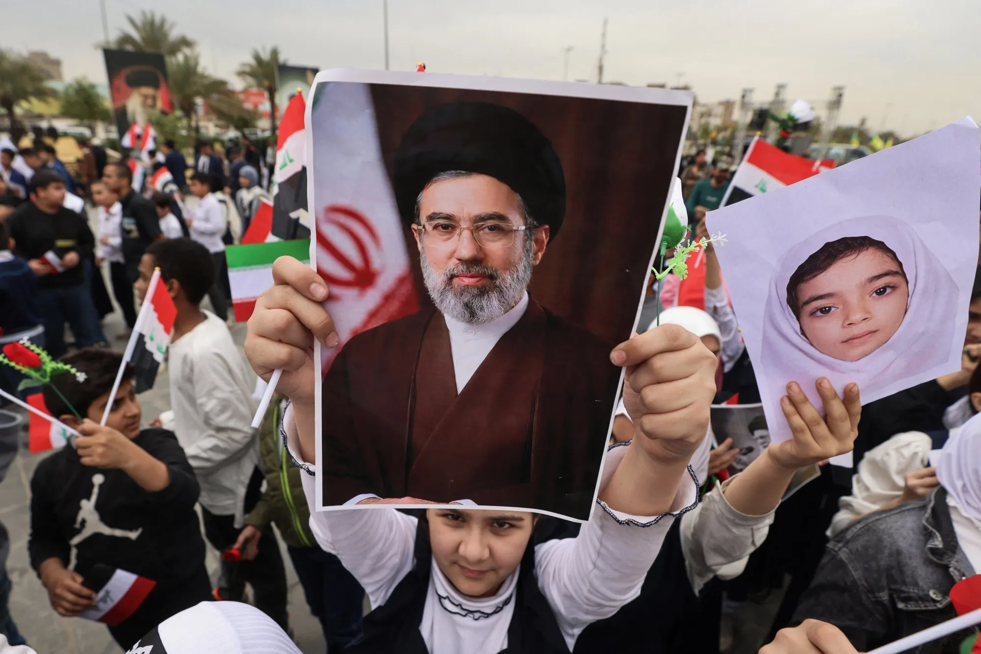 A schoolgirl holds a poster of Iran’s new supreme leader Mojtaba Khamenei during an anti-US and Israel demonstration in Baghdad on March 12.
