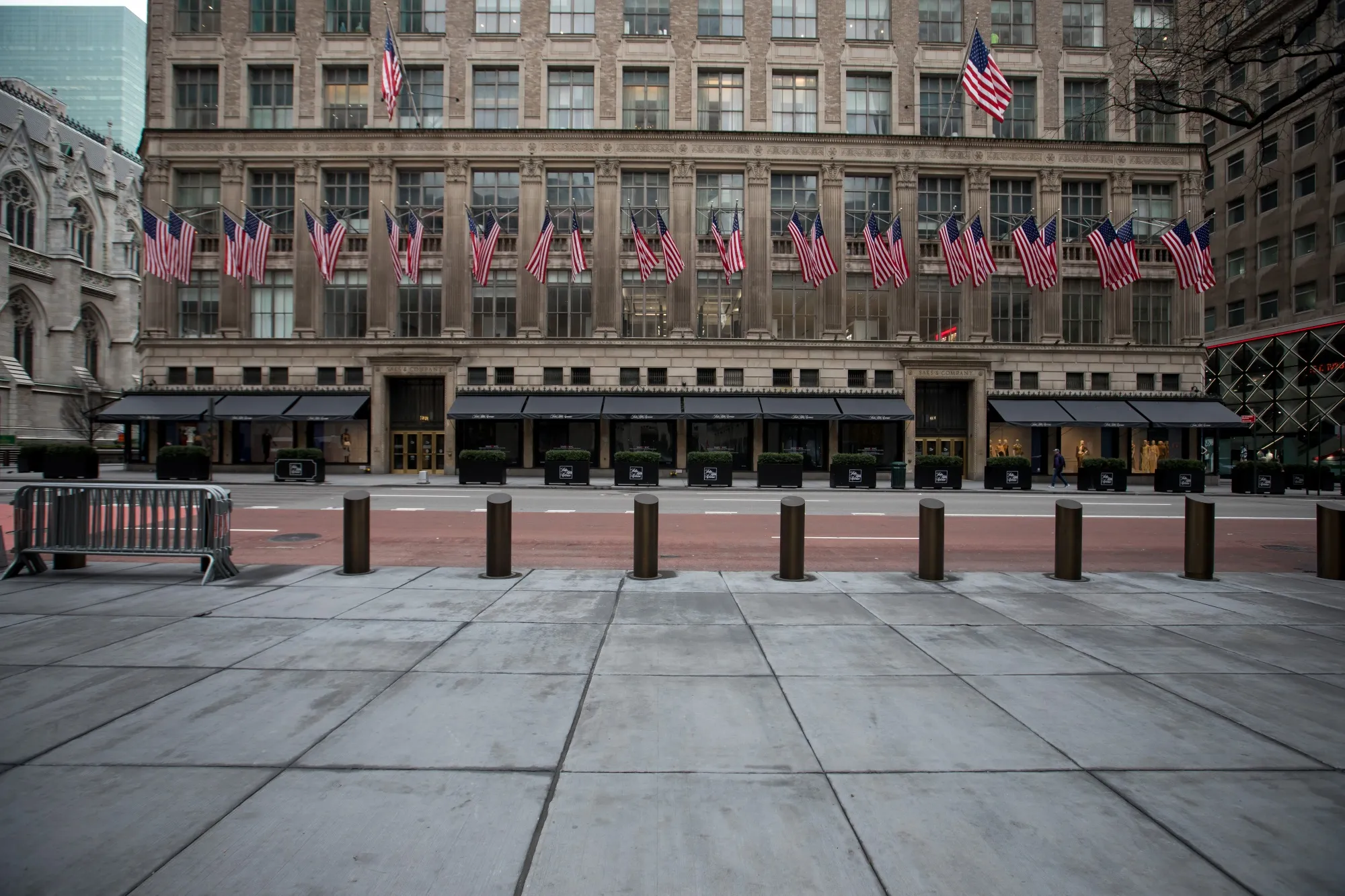 Empty sidewalks are seen in front of the Saks store in New York.