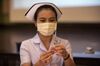 A nurse checks a dose of the AstraZeneca Covid-19 vaccine for air bubbles in Nonthaburi, Thailand, on March 12.