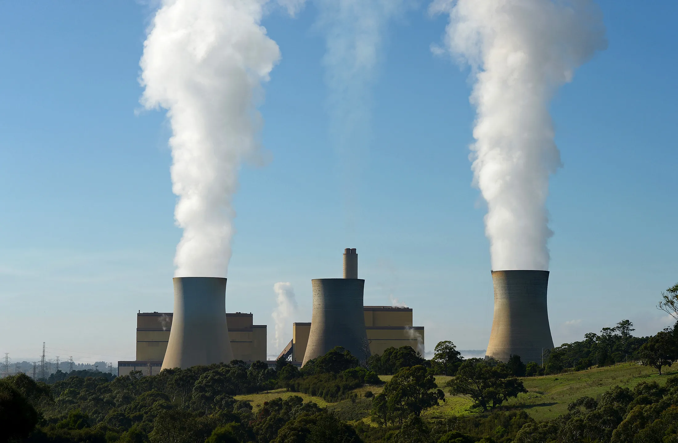 Steam billows from the cooling towers of the Yallourn coal-fired power station operated by EnergyAustralia Holdings, a unit of CLP Holdings, in the Latrobe Valley, Australia, on Wednesday, April 29, 2015.
