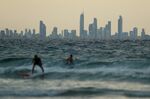 People surf at the Gold Coast town of Coolangatta near the Queensland, New South Wales border, March 2020.