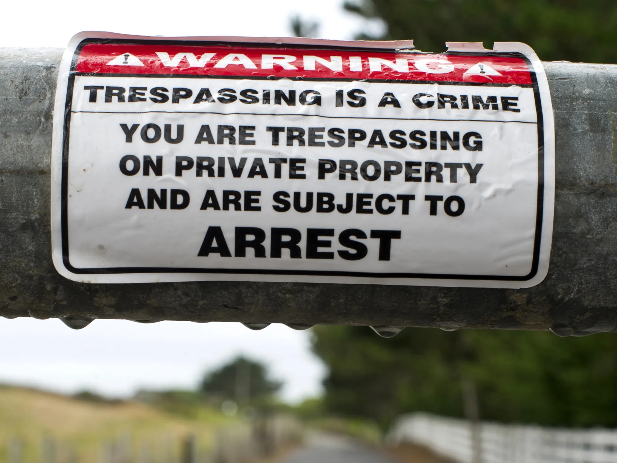 No trespassing signage is displayed on a gate leading to Martins Beach in Half Moon Bay, California, U.S., on Wednesday, July 16, 2014.

