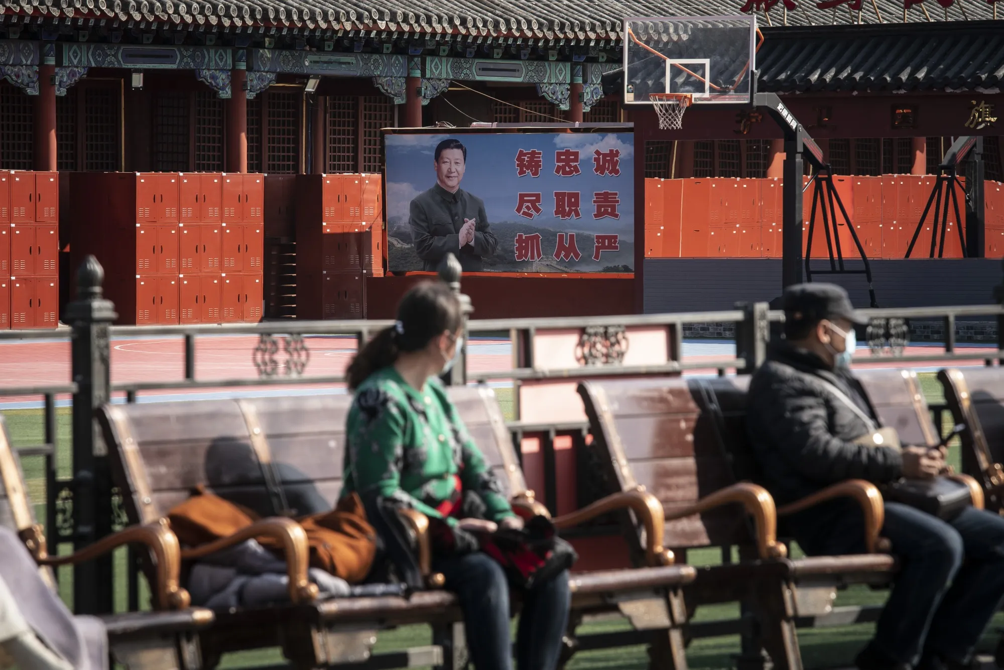 A billboard featuring Chinese President Xi Jinping at a People's Liberation Army Flag Guard barrack near the Forbidden City in Beijing, China.