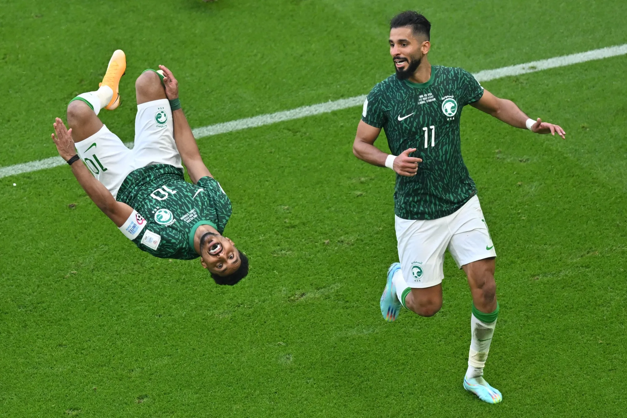 Salem Al-Dawsari of Saudi Arabia, left, celebrates scoring his team's second goal during their FIFA World Cup match against Argentina on Nov. 22.