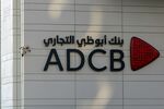 The Abu Dhabi Commercial Bank PJSC logo at one of the bank's main offices in Abu Dhabi. Photographer: Christopher Pike/Bloomberg