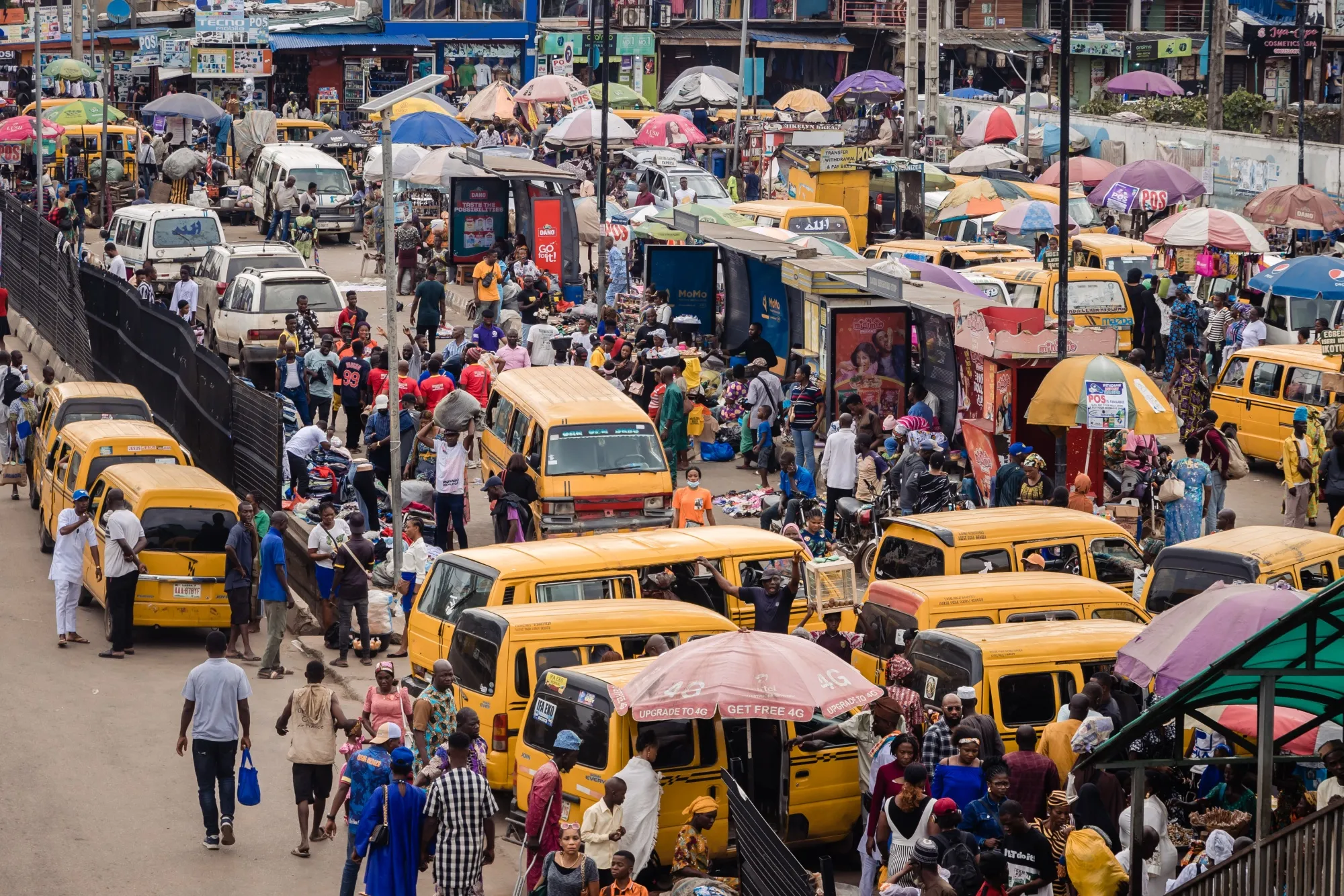 Market stall vendors and passengers at the Berger Bus Stop in Lagos, Nigeria