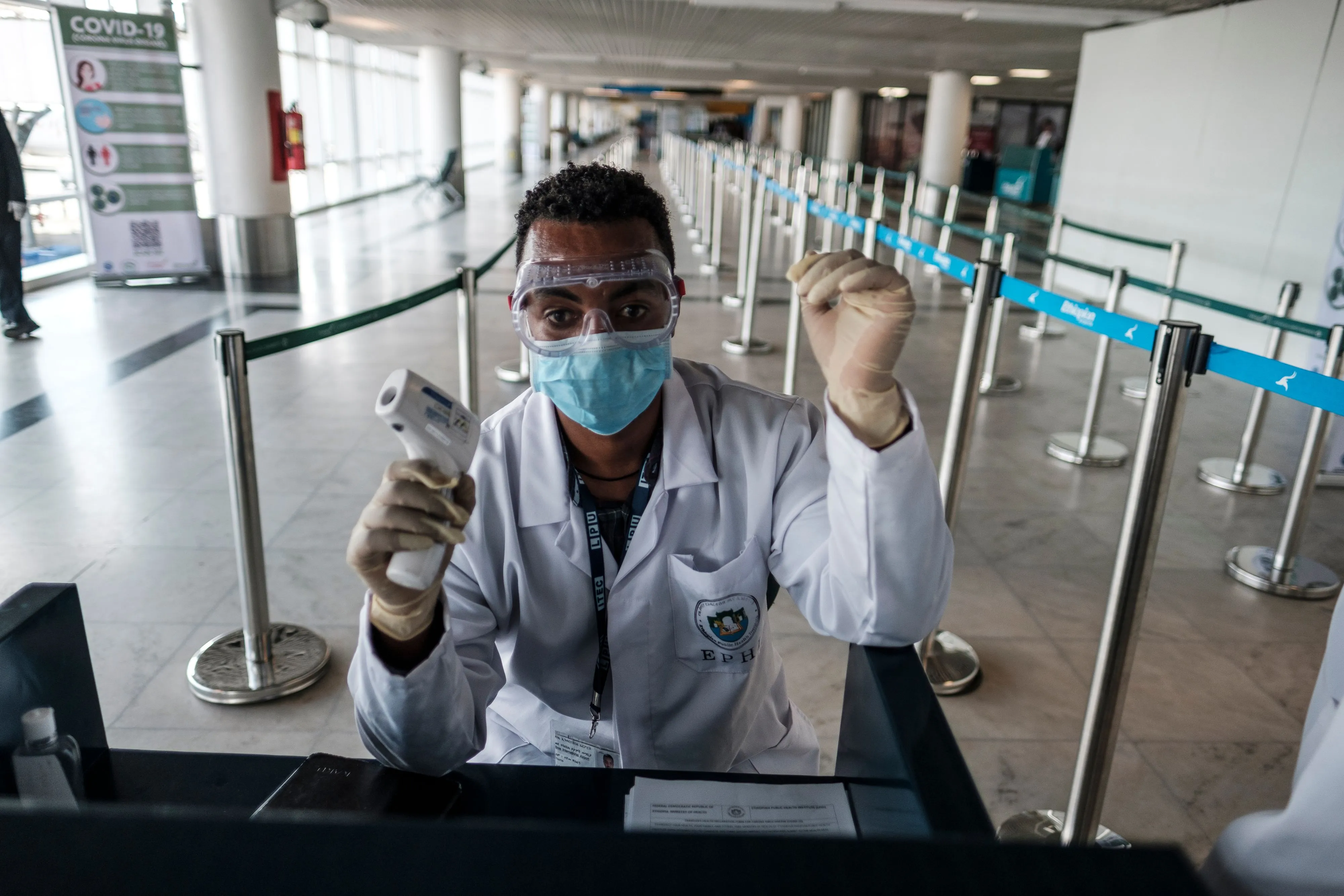 A worker of the Ethiopian Public Health Institute (EPHI) works at a temperature control point at the Bole International Airport.