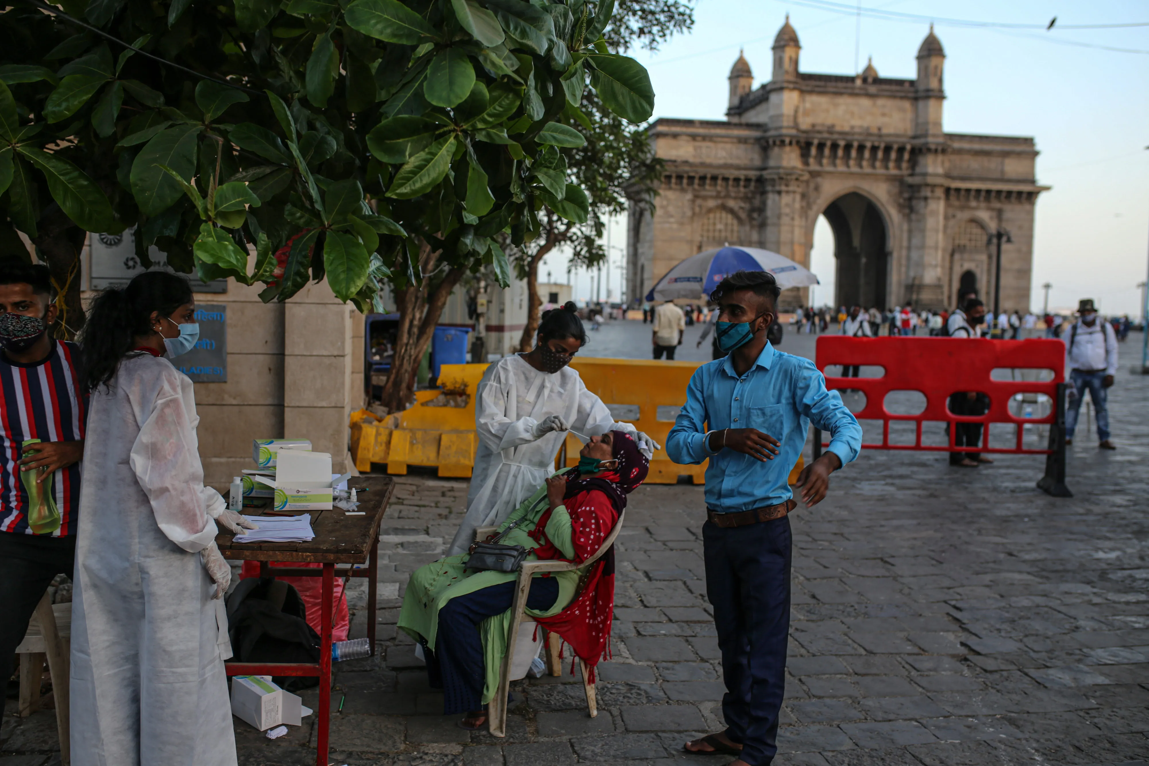 A healthcare worker administers a rapid antigen test near the Gateway of India monument in Mumbai on March 31.