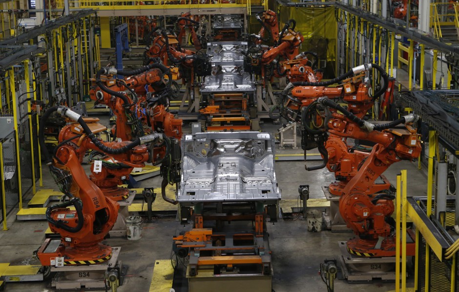 Robotic arms work at Chrysler's assembly plant in Warren, Michigan, in 2013.