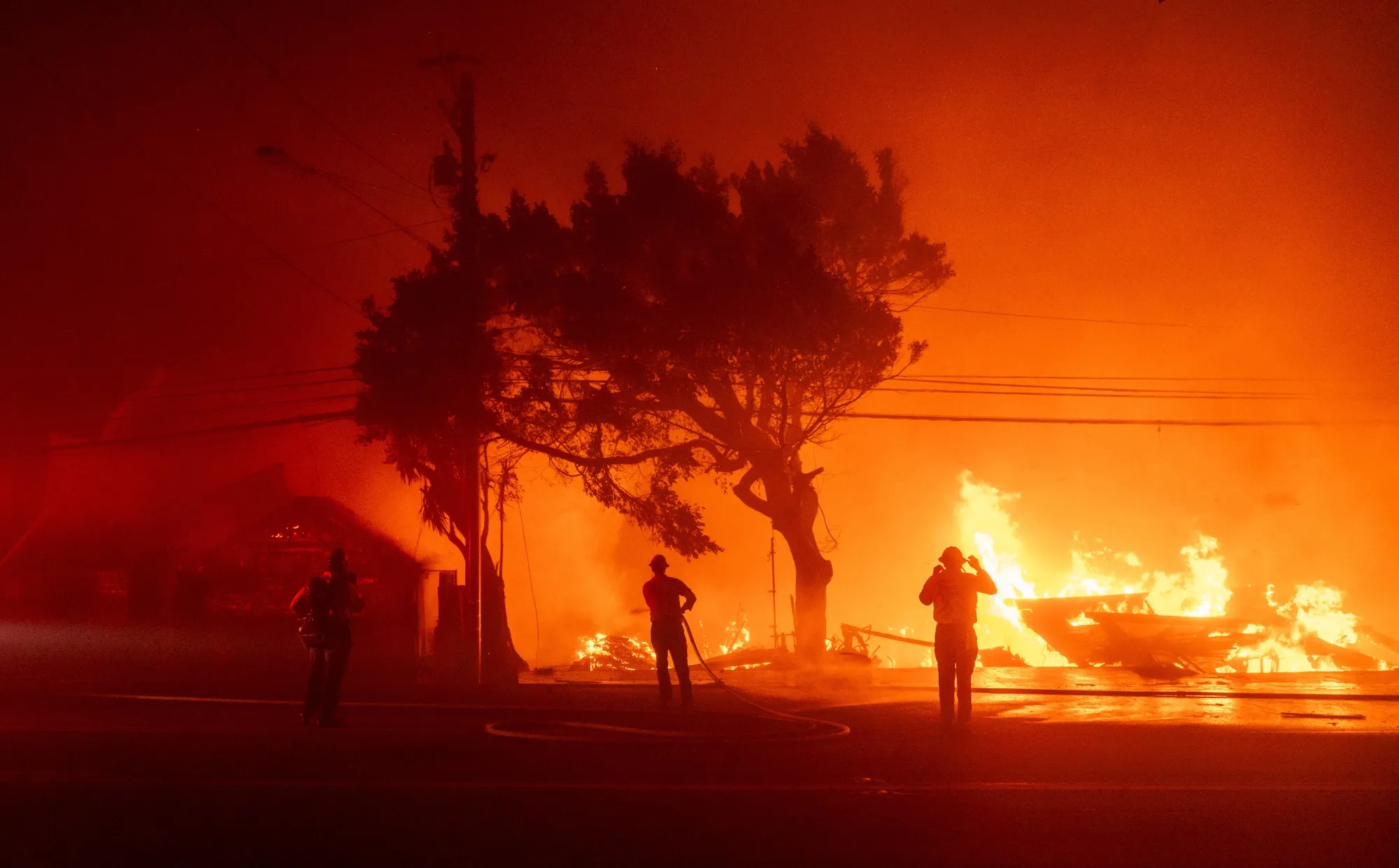 Firefighters battle flames during the Palisades Fire in the Pacific Palisades neighborhood of Los Angeles in January 2025.