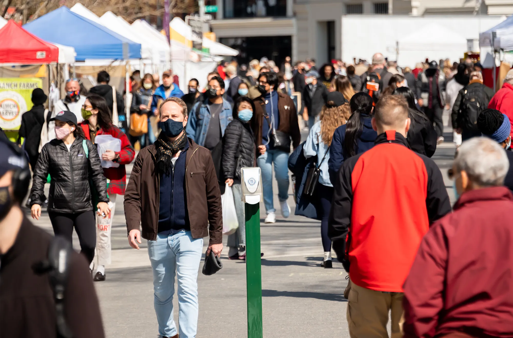People walk through the Union Square Greenmarket in New York March 10.