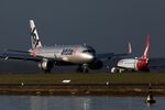 An Airbus SE A320 aircraft operated by Qantas Airways Ltd.'s low-cost unit Jetstar Airways, left, lands at Sydney Airport in Sydney, Australia, on Monday, Feb. 24, 2025. Qantas Airways is scheduled to release earnings figures on Feb. 25.