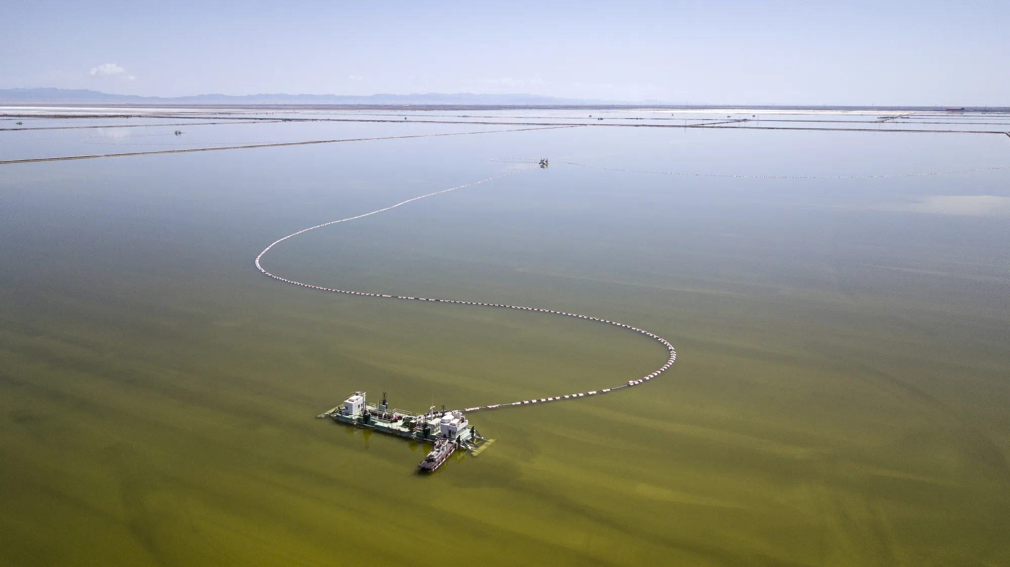 A barge pumps brine from an evaporation pond operated by Qinghai Salt Lake Industry Co. in Golmud, Qinghai.