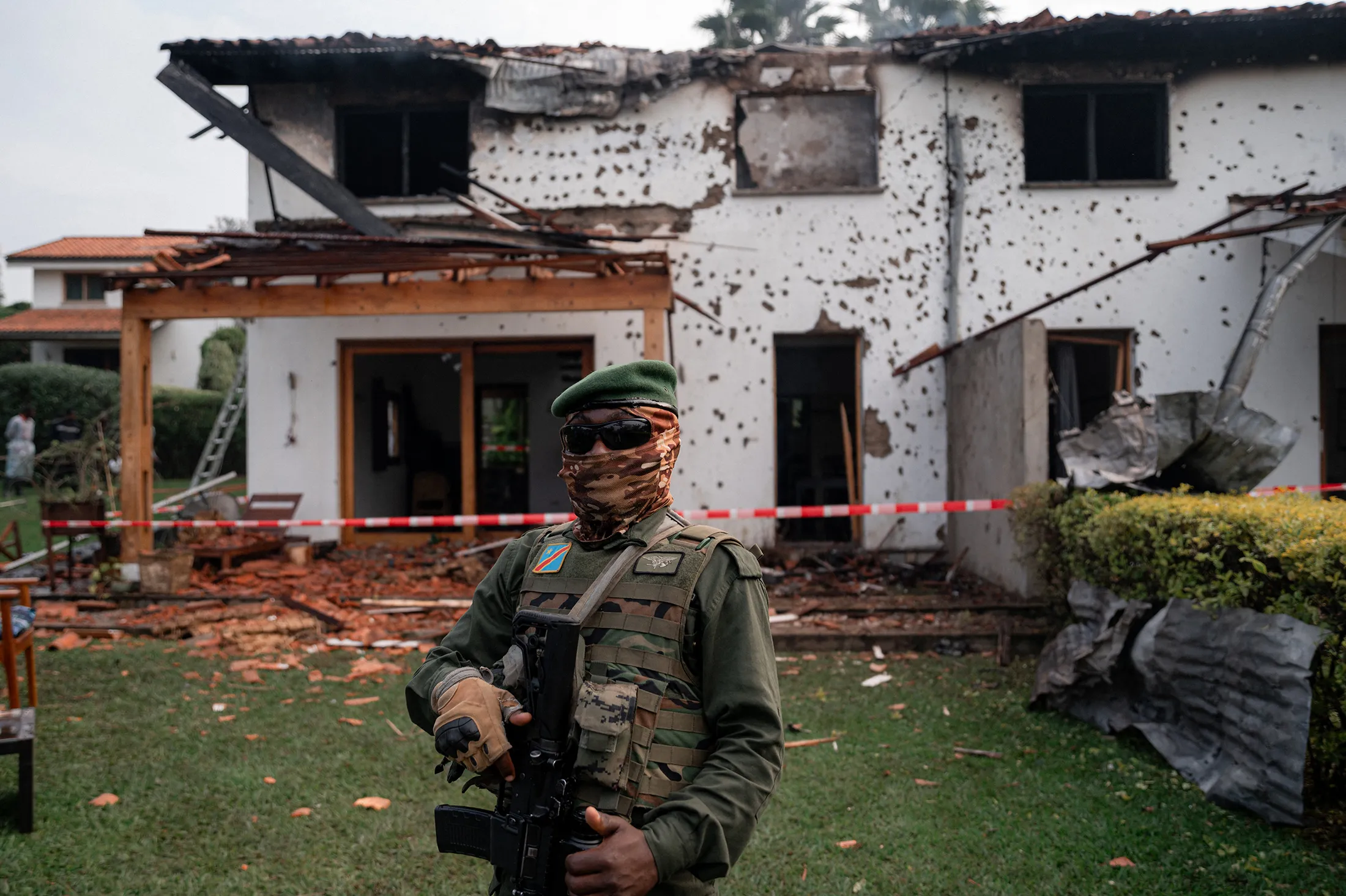 A&nbsp;M23 member stands near a private residence damaged by a drone strike in Goma, Democratic Republic of the Congo, on March 11.