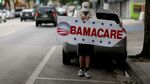 Pedro Rojas holds a sign directing people to an insurance company where they can sign up for the Affordable Care Act, also known as Obamacare, before the February 15th deadline on February 5, 2015 in Miami, Florida.
