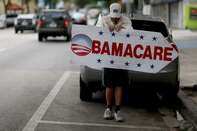 Pedro Rojas holds a sign directing people to an insurance company where they can sign up for the Affordable Care Act, also known as Obamacare, before the February 15th deadline on February 5, 2015 in Miami, Florida.
