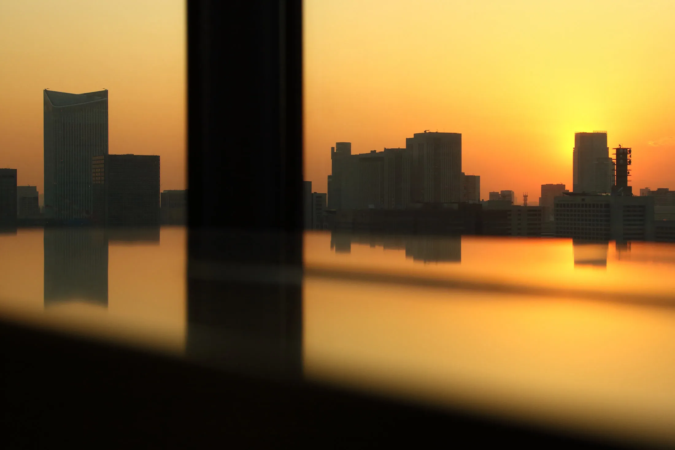 Commercial and residential buildings stand at dusk in Tokyo.
