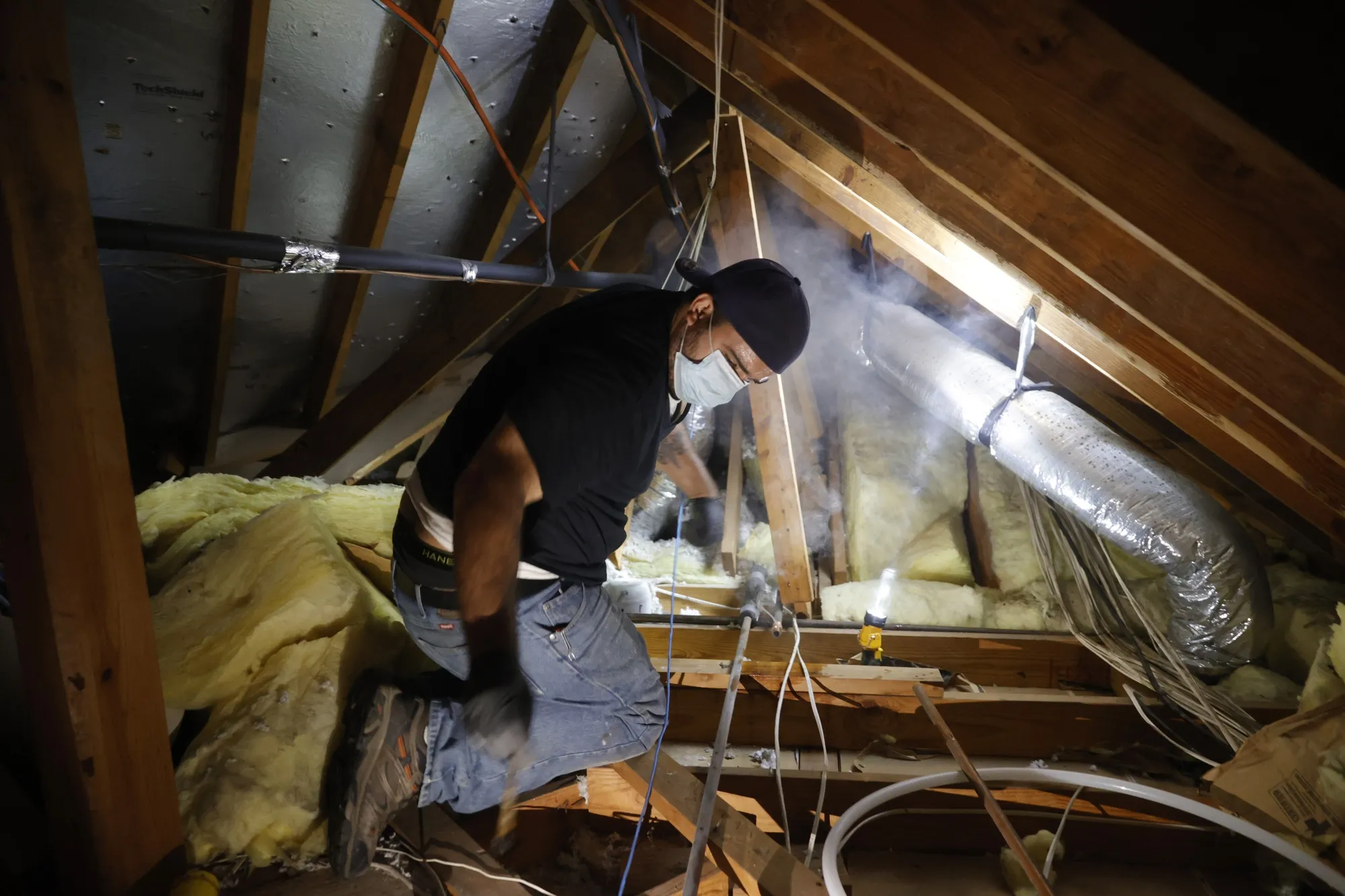 A plumber repairs a burst pipe in a home in Houston on Feb. 21.