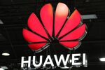 A Huawei illuminated logo hangs above the Huawei Technologies Co. stand of the MWC Barcelona.