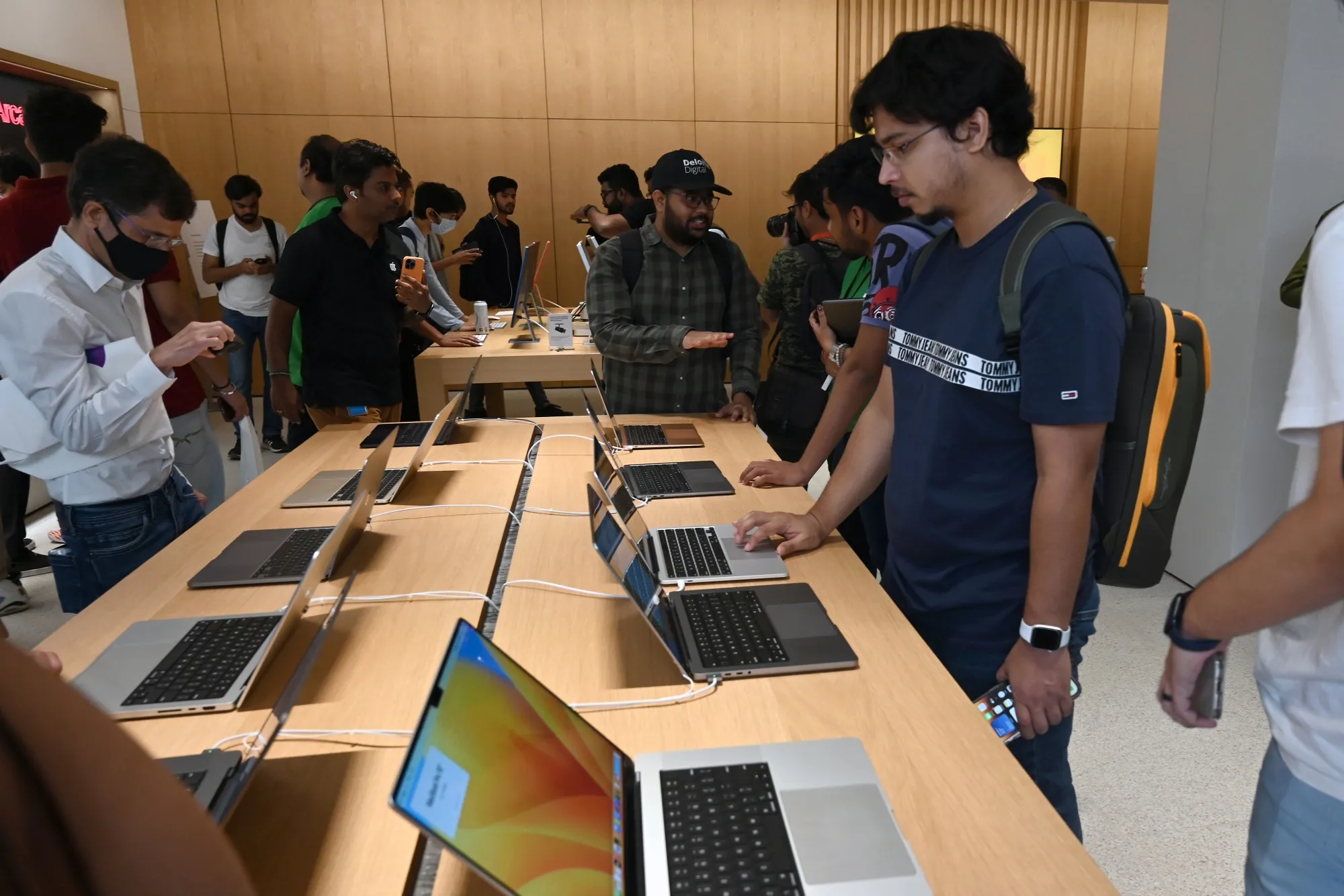 Customers look at Apple&nbsp;laptop computers at the new Apple Saket store during its opening in New Delhi, India.