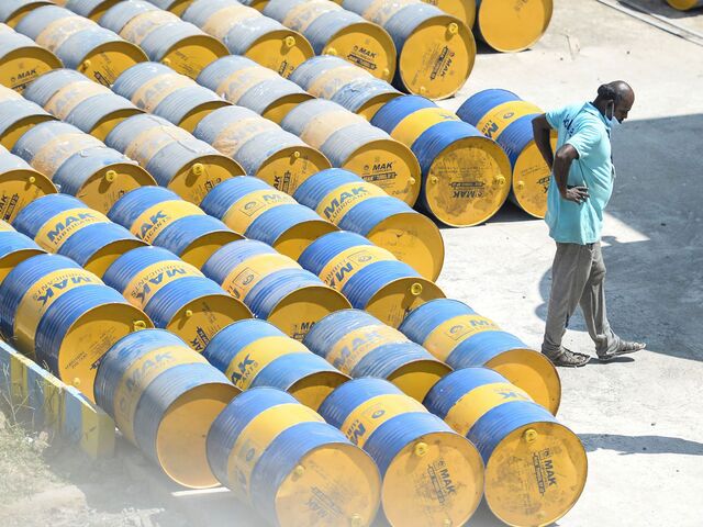 A worker stacks oil barrels at a filling station in n Chennai on February 24, 2022.