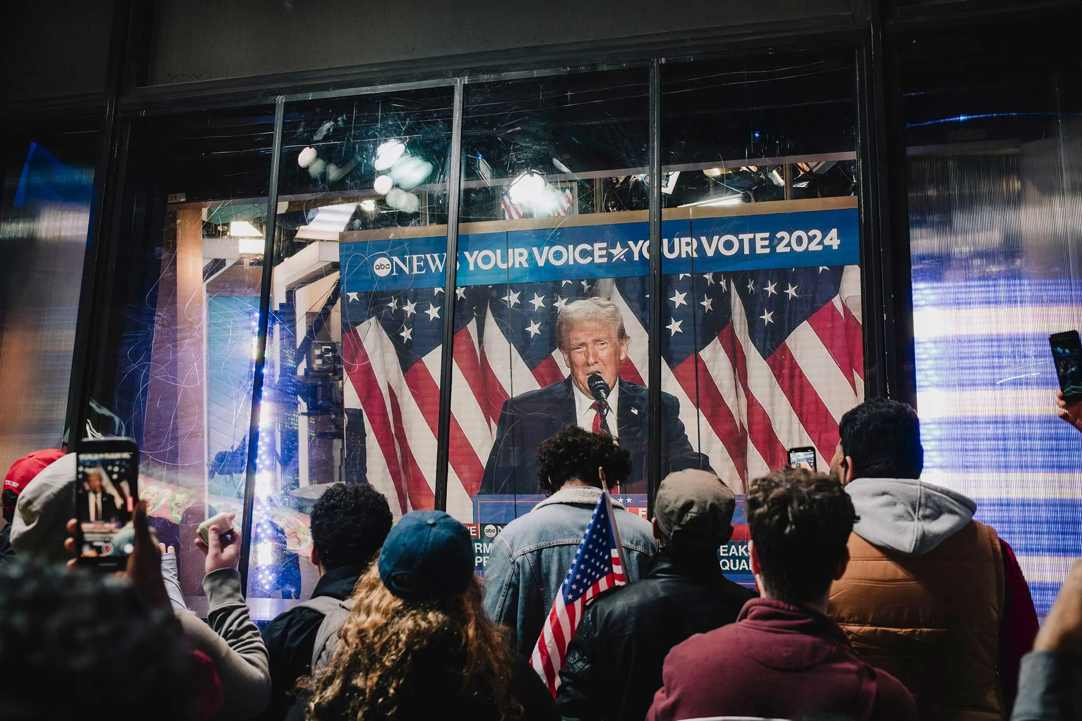 Onlookers in Times Square watch Donald Trump address&nbsp;his election night party early Wednesday morning.