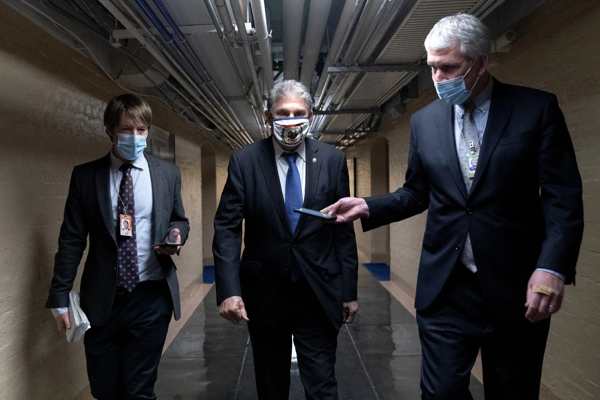 Joe Manchin, center, speaks to members of the media at the U.S. Capitol on March 5.