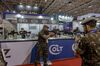Brazilian Armed Forces soldiers view guns at the Colt booth during the Latin American Aerospace & Defense conference and exhibition in Rio de Janeiro in April 2023.