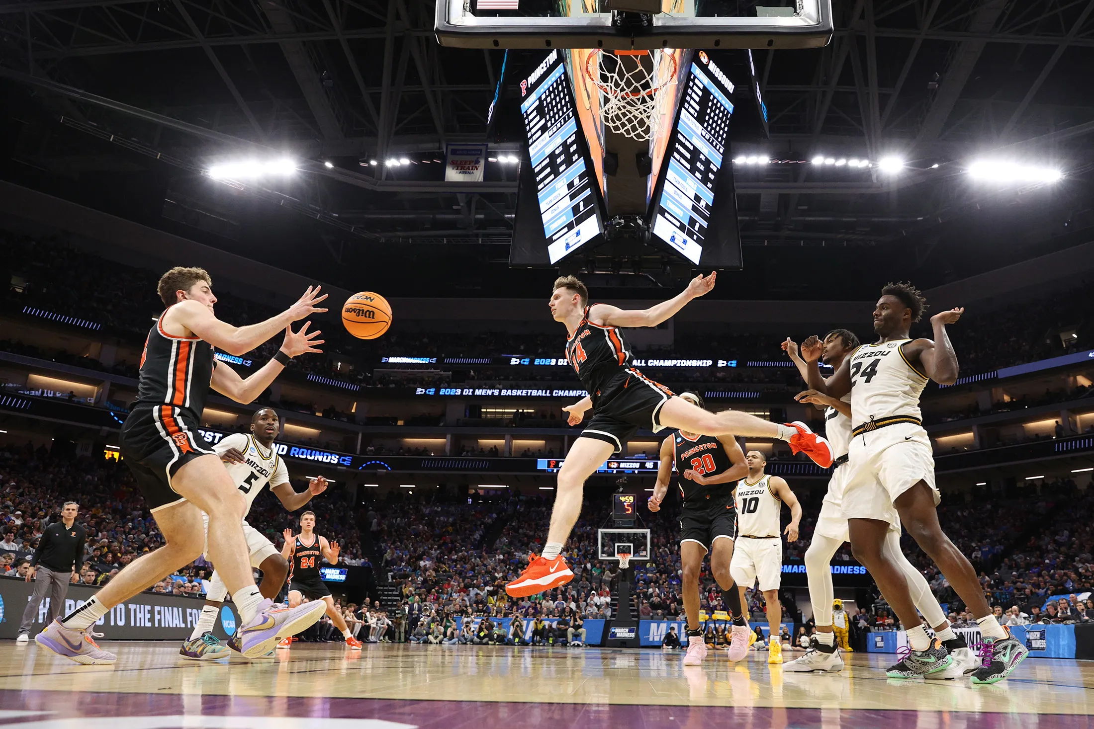Matt Allocco of the Princeton Tigers passes to teammate Caden Pierce during a game against Missouri Tin the second round of the NCAA Men’s Basketball Tournament.