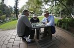 Men play chess in Hyde Park in Sydney.