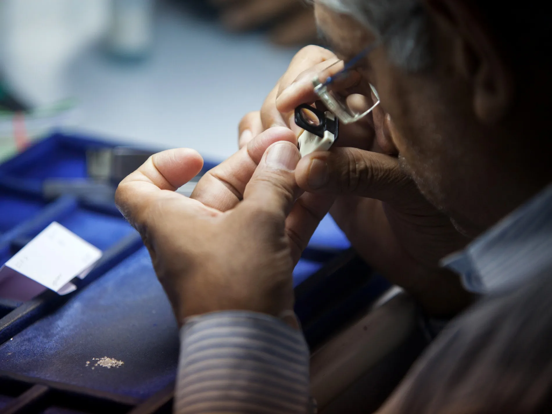A rough diamond is inspected at a &nbsp;workshop in India.