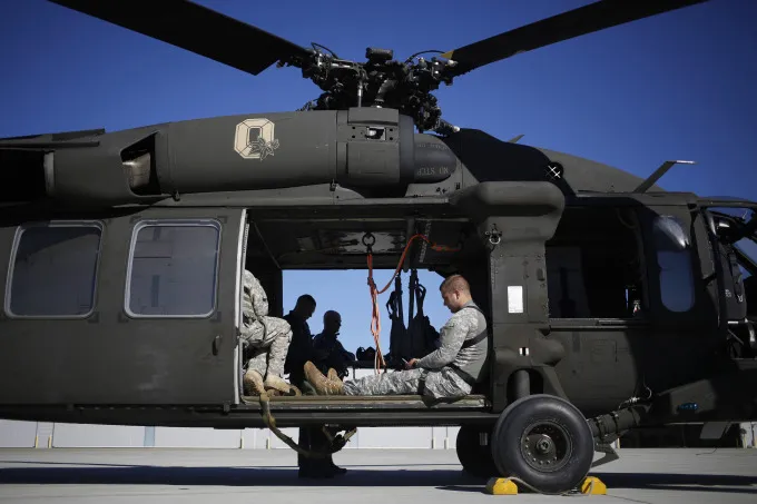 Kentucky Army National Guardsmen wait on board a Sikorsky Aircraft Corp. UH-60 Blackhawk helicopter at the Kentucky State Police Cannabis Suppression Branch headquarters in London, Kentucky, U.S., on Monday, Sept. 14, 2015. Funded by federal grant money, the Kentucky State Troopers and Kentucky Army National Guard work together to enforce marijuana laws including destroying illegal grow operations throughout the state.